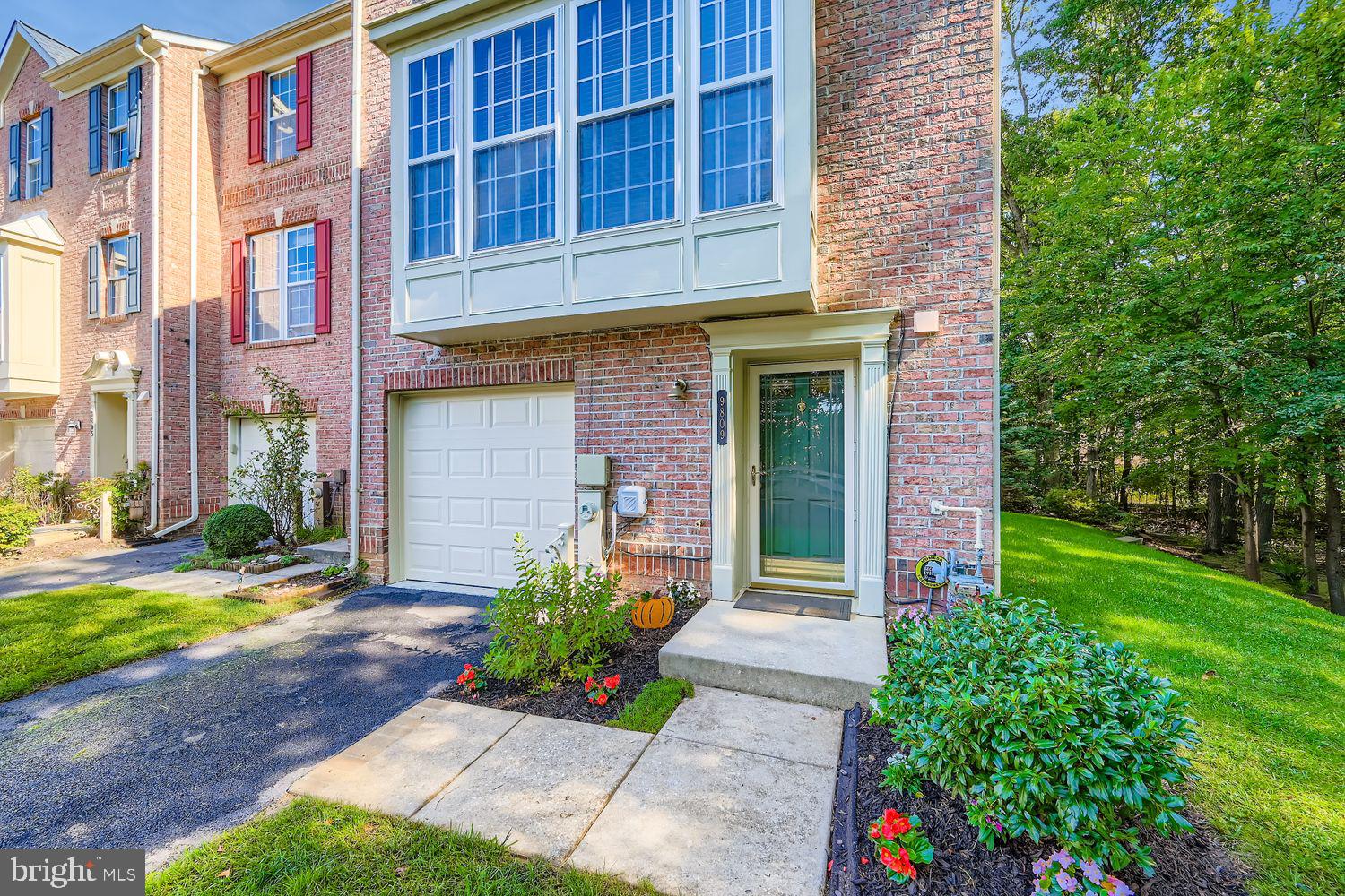 9809 Redwing Drive, Unit 9809 Perry Hall, MD 21128 - Photo 2 of 42 a front view of a house with a yard and outdoor seating