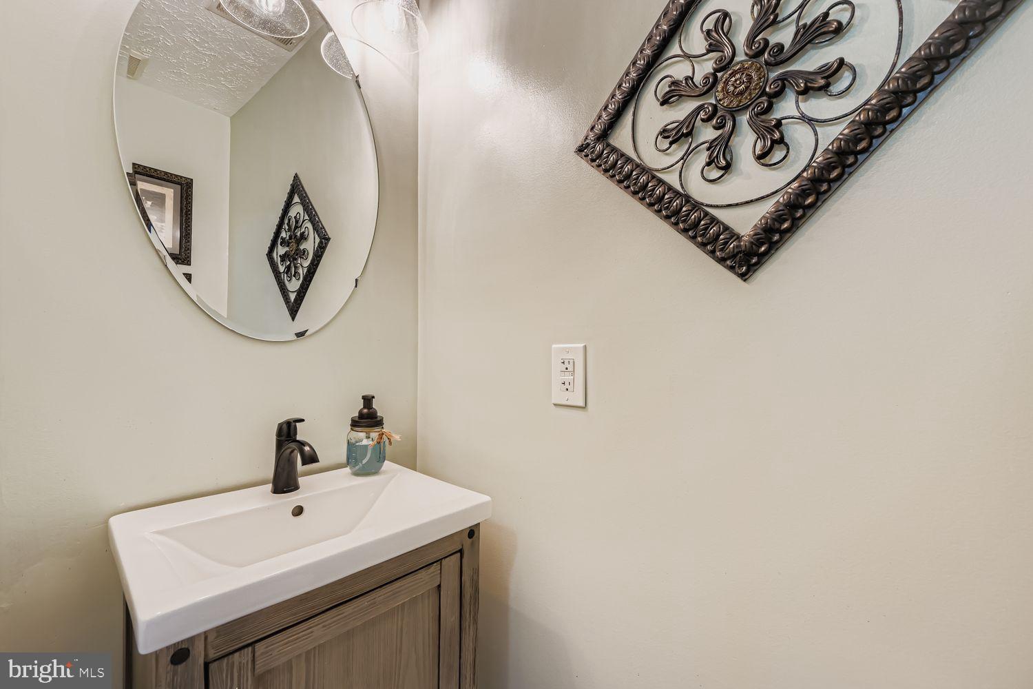 9809 Redwing Drive, Unit 9809 Perry Hall, MD 21128 - Photo 29 of 42 a bathroom with a sink and a mirror