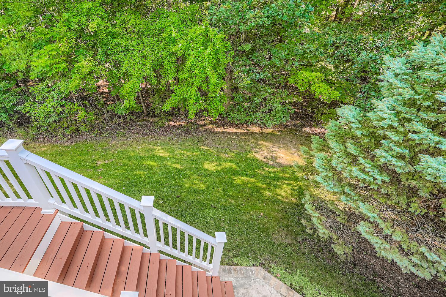 9809 Redwing Drive, Unit 9809 Perry Hall, MD 21128 - Photo 35 of 42 a view of a wooden deck with a yard