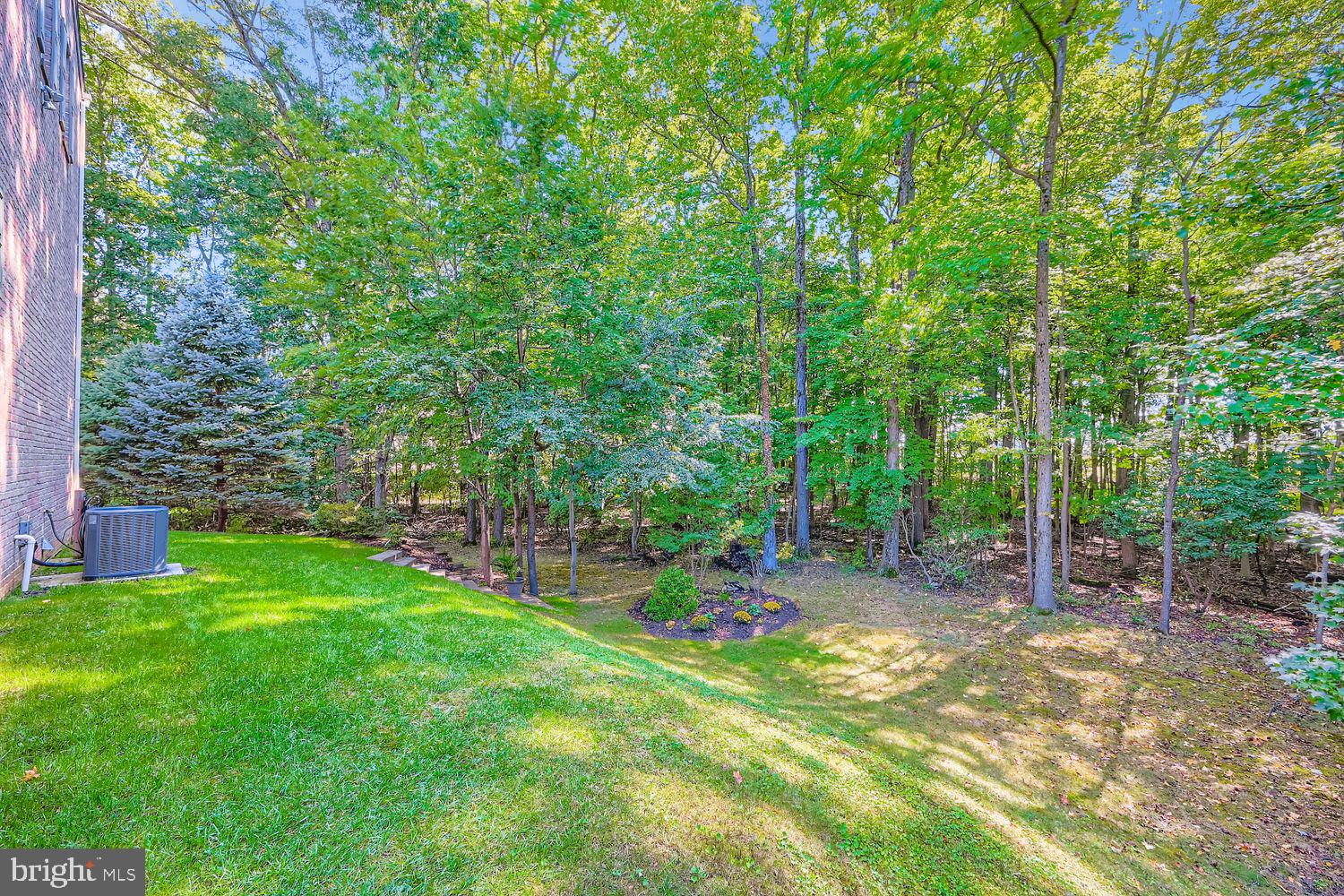 9809 Redwing Drive, Unit 9809 Perry Hall, MD 21128 - Photo 36 of 42 a view of a backyard with table and chairs and wooden fence
