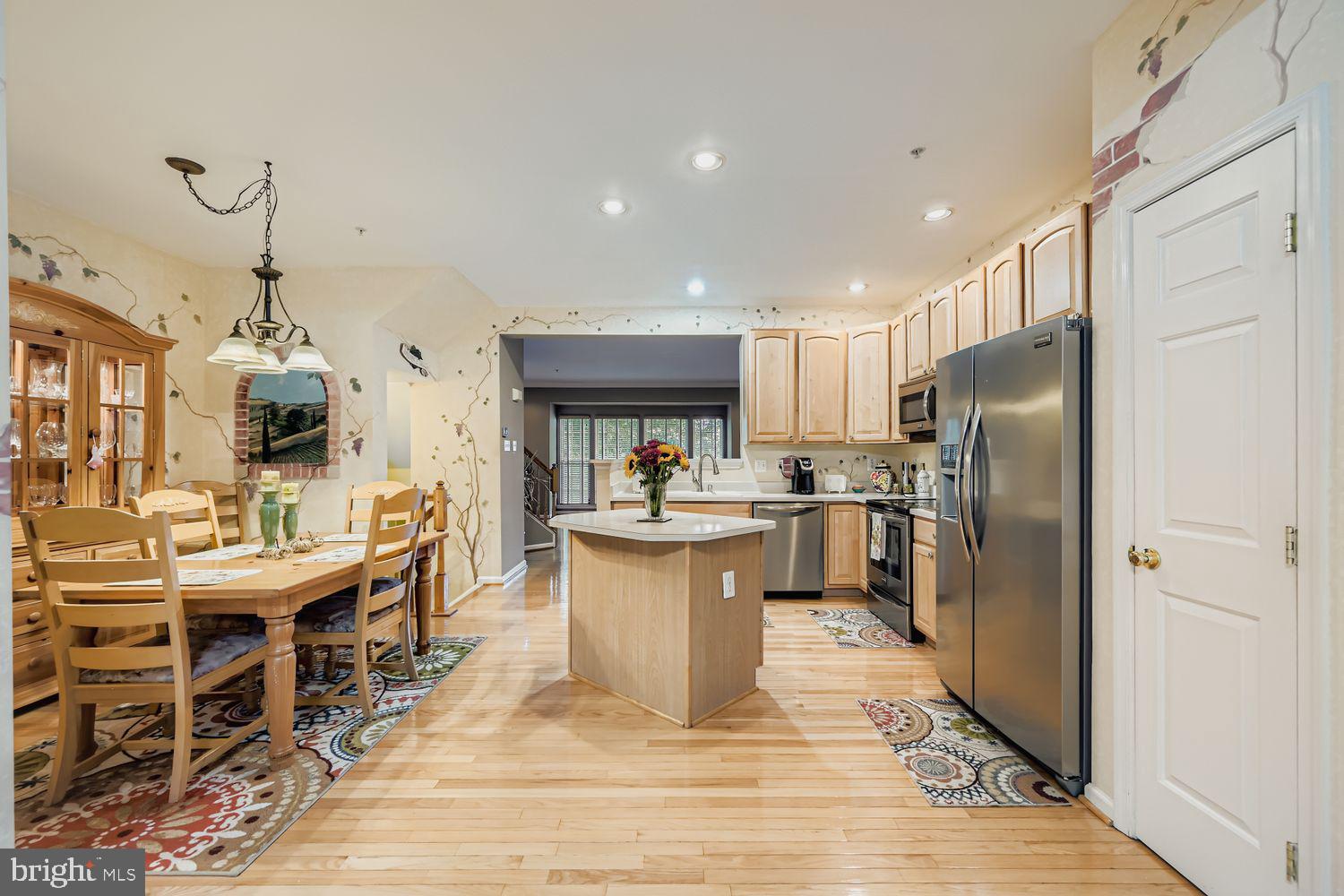 9809 Redwing Drive, Unit 9809 Perry Hall, MD 21128 - Photo 42 of 42 a kitchen with stainless steel appliances kitchen island granite countertop a sink a stove and a refrigerator
