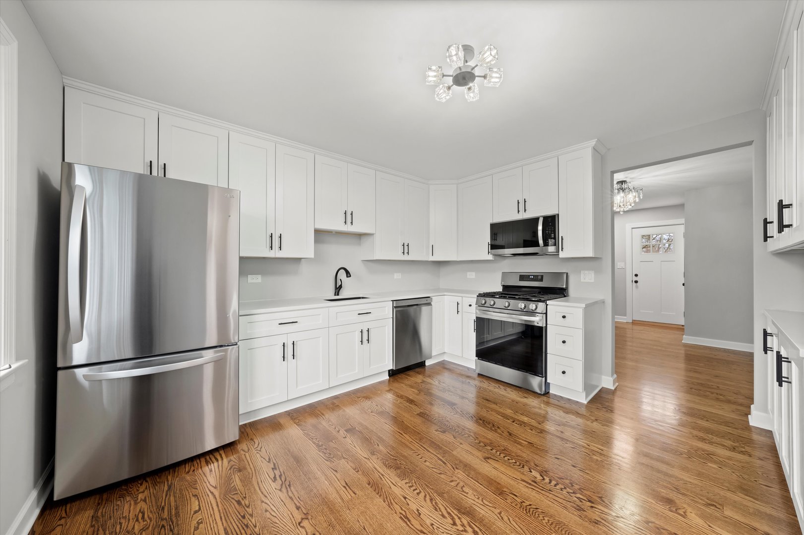 5426 Wolf Road Western Springs, IL 60558 - Photo 4 of 19 a kitchen with cabinets stainless steel appliances and wooden floor