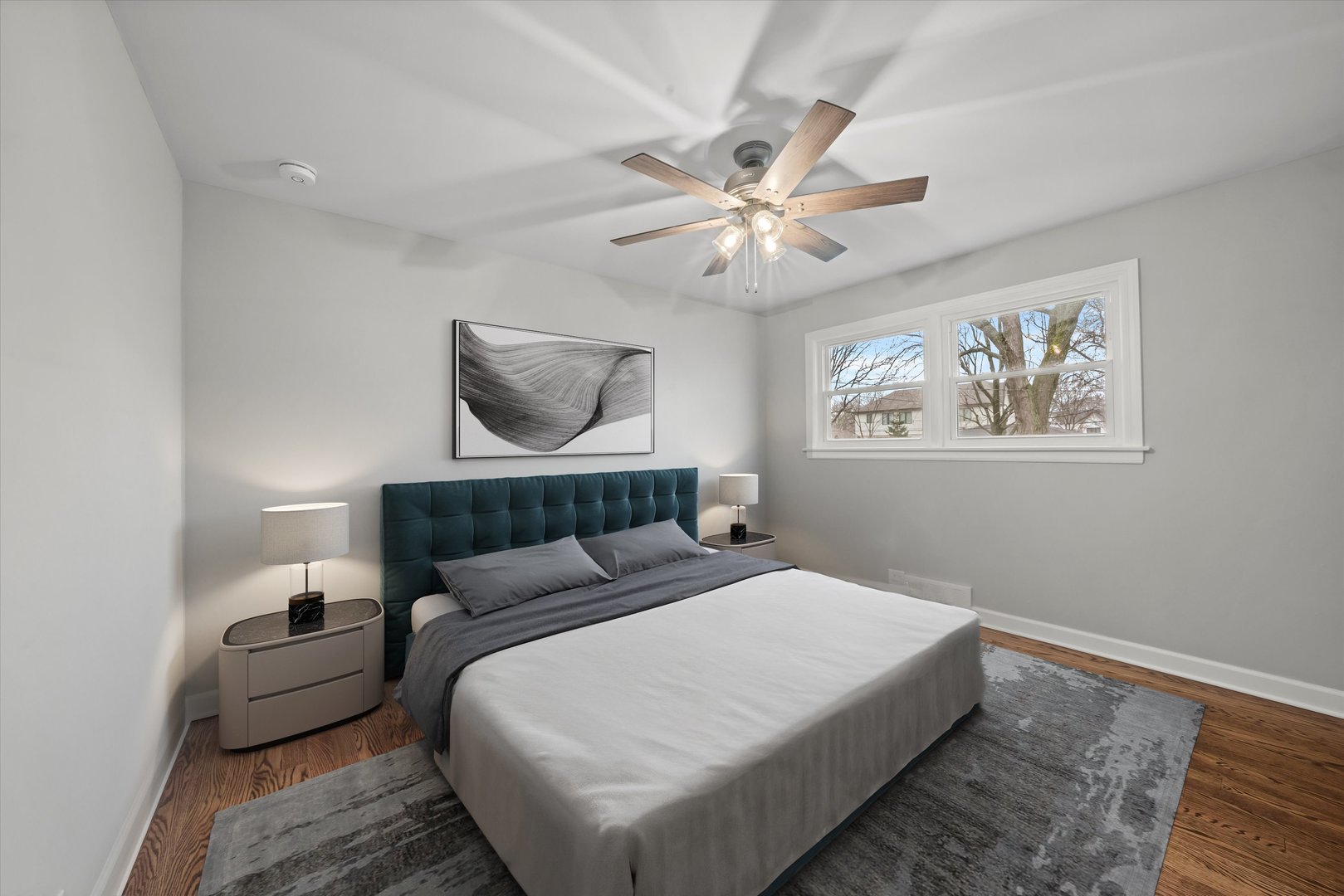 5426 Wolf Road Western Springs, IL 60558 - Photo 7 of 19 a bedroom with a large bed and a chandelier