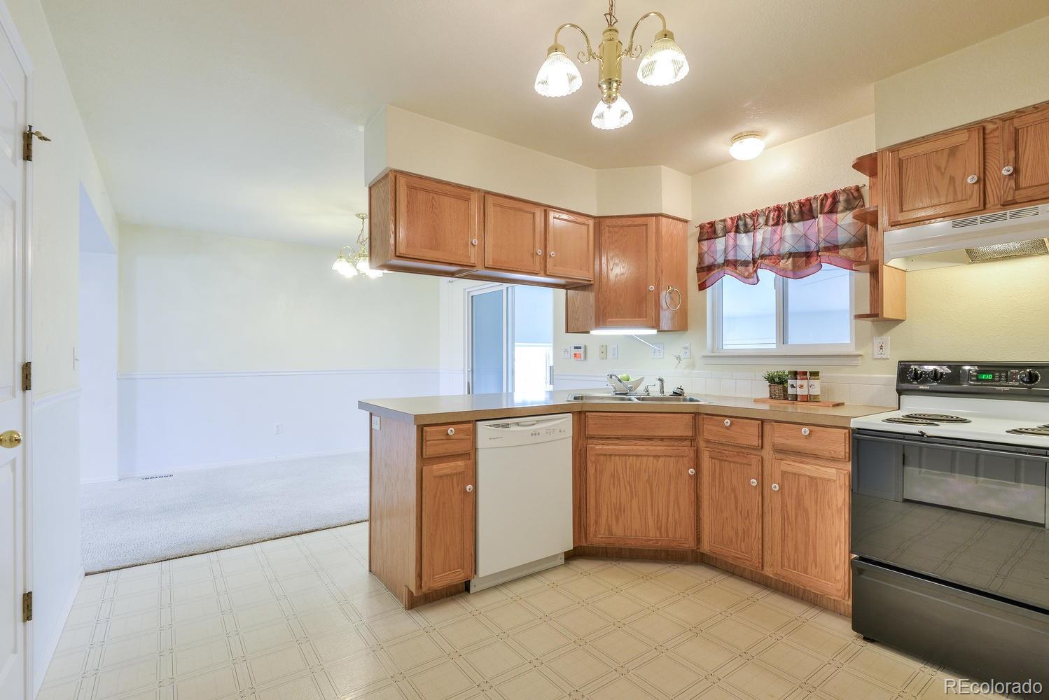 1437 Walnut Street Windsor, CO 80550 - Photo 11 of 35 a kitchen with cabinets a sink and appliances