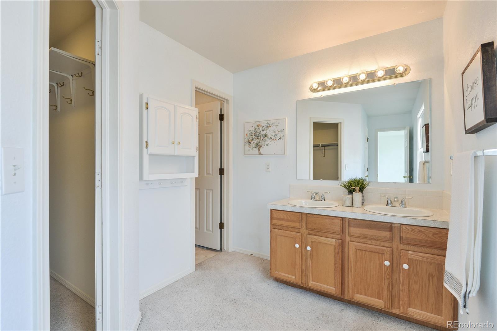 1437 Walnut Street Windsor, CO 80550 - Photo 18 of 35 a spacious bathroom with a double vanity sink a mirror and a shower