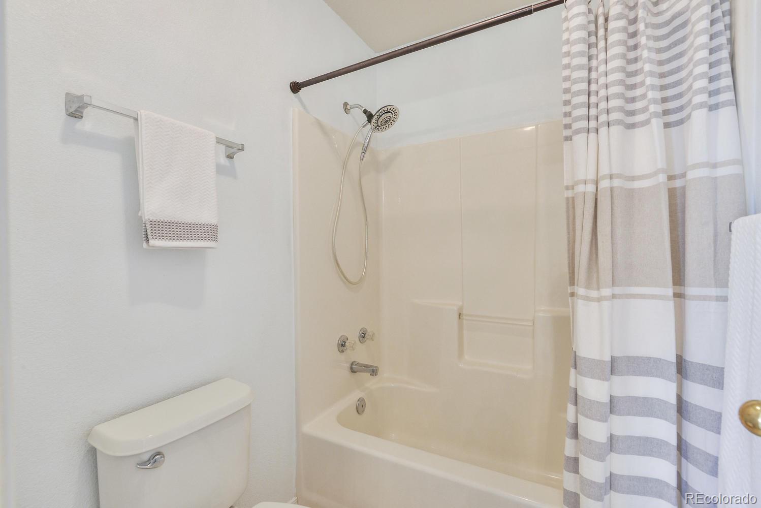 1437 Walnut Street Windsor, CO 80550 - Photo 19 of 35 a bathroom with a shower and a toilet