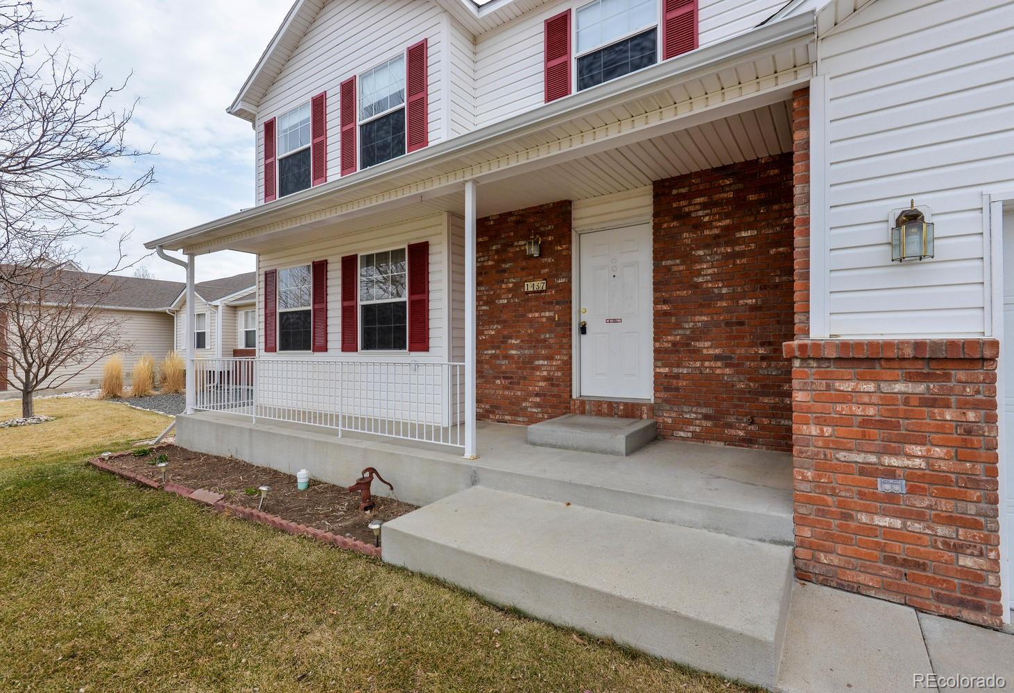 1437 Walnut Street Windsor, CO 80550 - Photo 2 of 35 front view of a brick house with a large windows