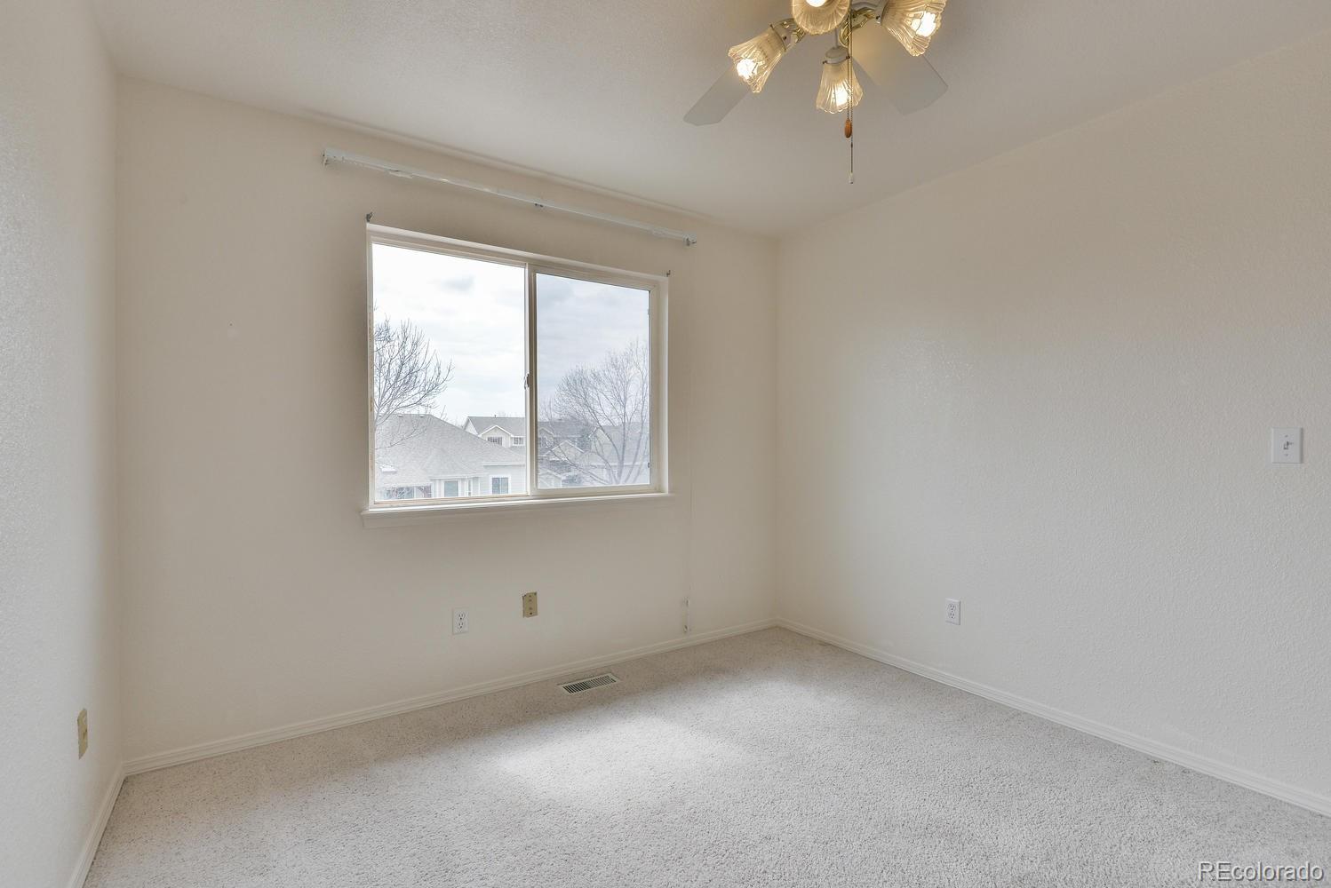 1437 Walnut Street Windsor, CO 80550 - Photo 21 of 35 an empty room with a window