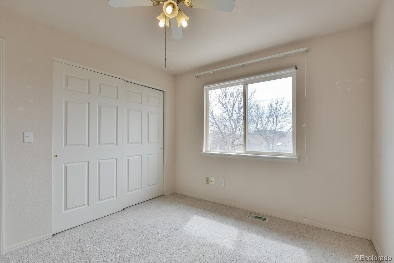 1437 Walnut Street Windsor, CO 80550 - Photo 24 of 35 an empty room with chandelier fan