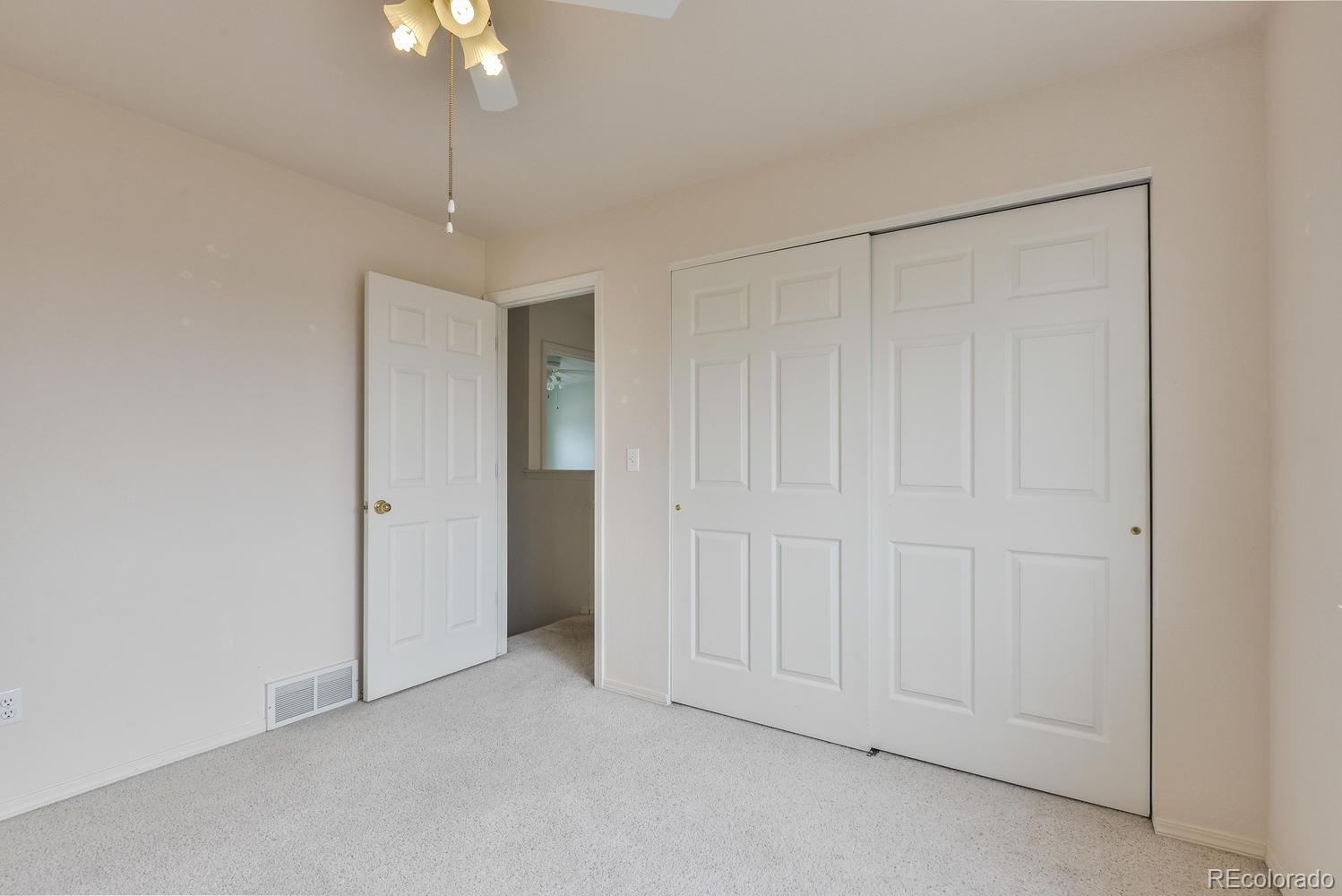 1437 Walnut Street Windsor, CO 80550 - Photo 25 of 35 an empty room with a ceiling fan