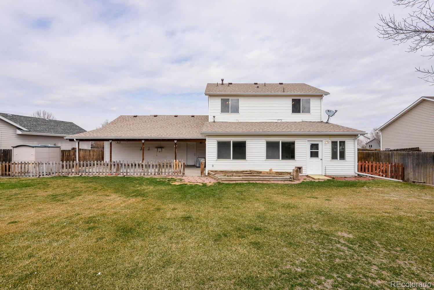 1437 Walnut Street Windsor, CO 80550 - Photo 28 of 35 a front view of a house with a garden