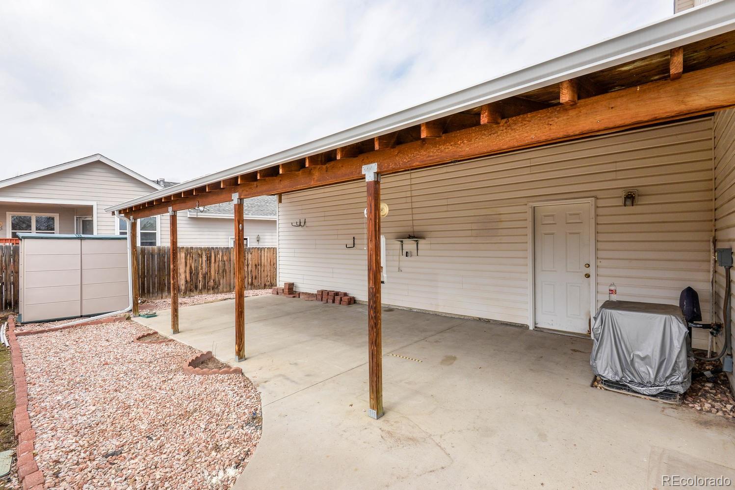 1437 Walnut Street Windsor, CO 80550 - Photo 29 of 35 a backyard of a house with table and chairs