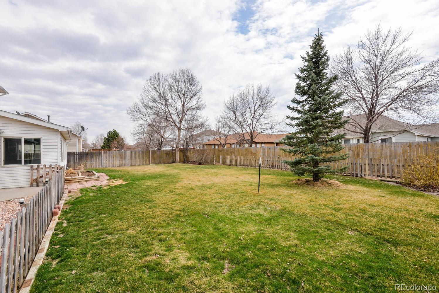 1437 Walnut Street Windsor, CO 80550 - Photo 31 of 35 a view of a yard with a house