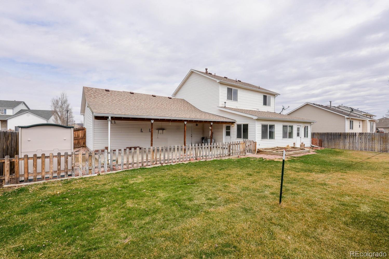 1437 Walnut Street Windsor, CO 80550 - Photo 33 of 35 a front view of a house with a yard