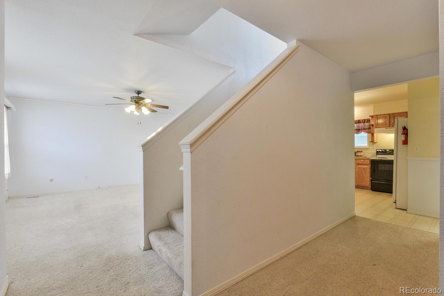 1437 Walnut Street Windsor, CO 80550 - Photo 4 of 35 a view of a kitchen with a refrigerator a sink and dishwasher