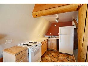 171 Z (aka Barking Dog Rd) Road Silverthorne, CO 80498 - Photo 11 of 25 a kitchen with a stove a refrigerator and a microwave