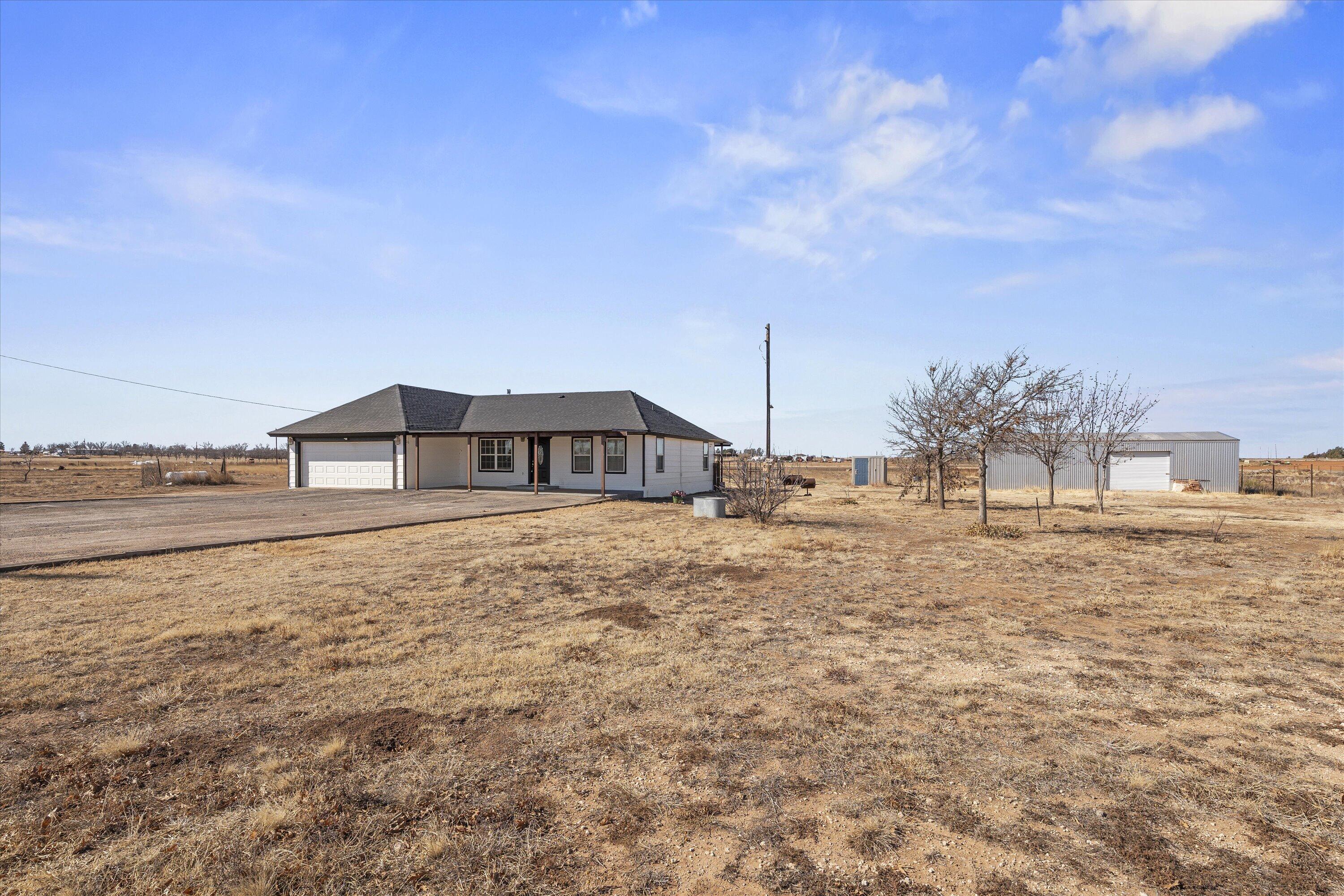 3131 North Alamo Road Levelland, TX 79336 - Photo 2 of 32 a front view of a house with a yard