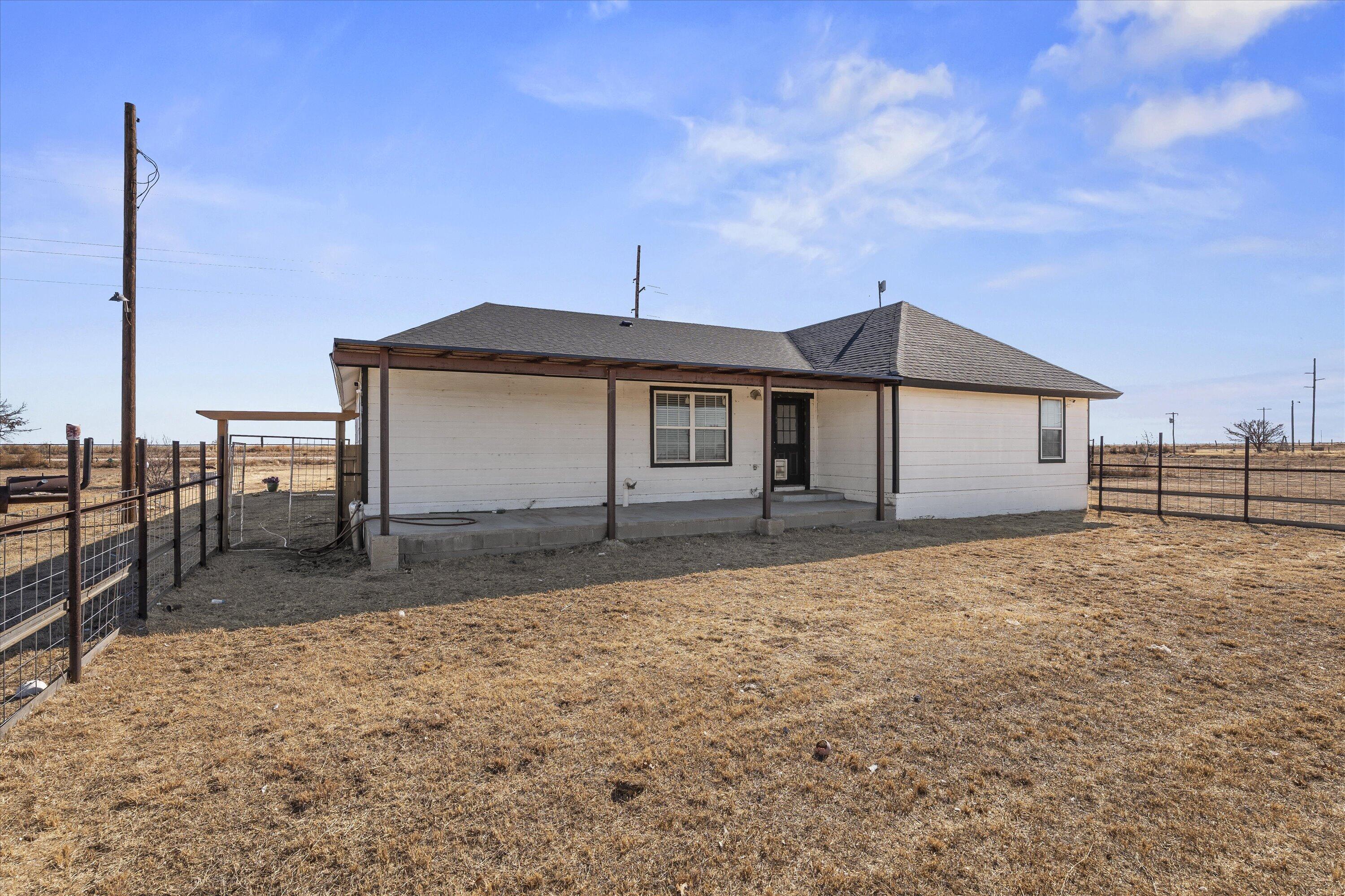 3131 North Alamo Road Levelland, TX 79336 - Photo 24 of 32 a front view of a house with a yard and garage