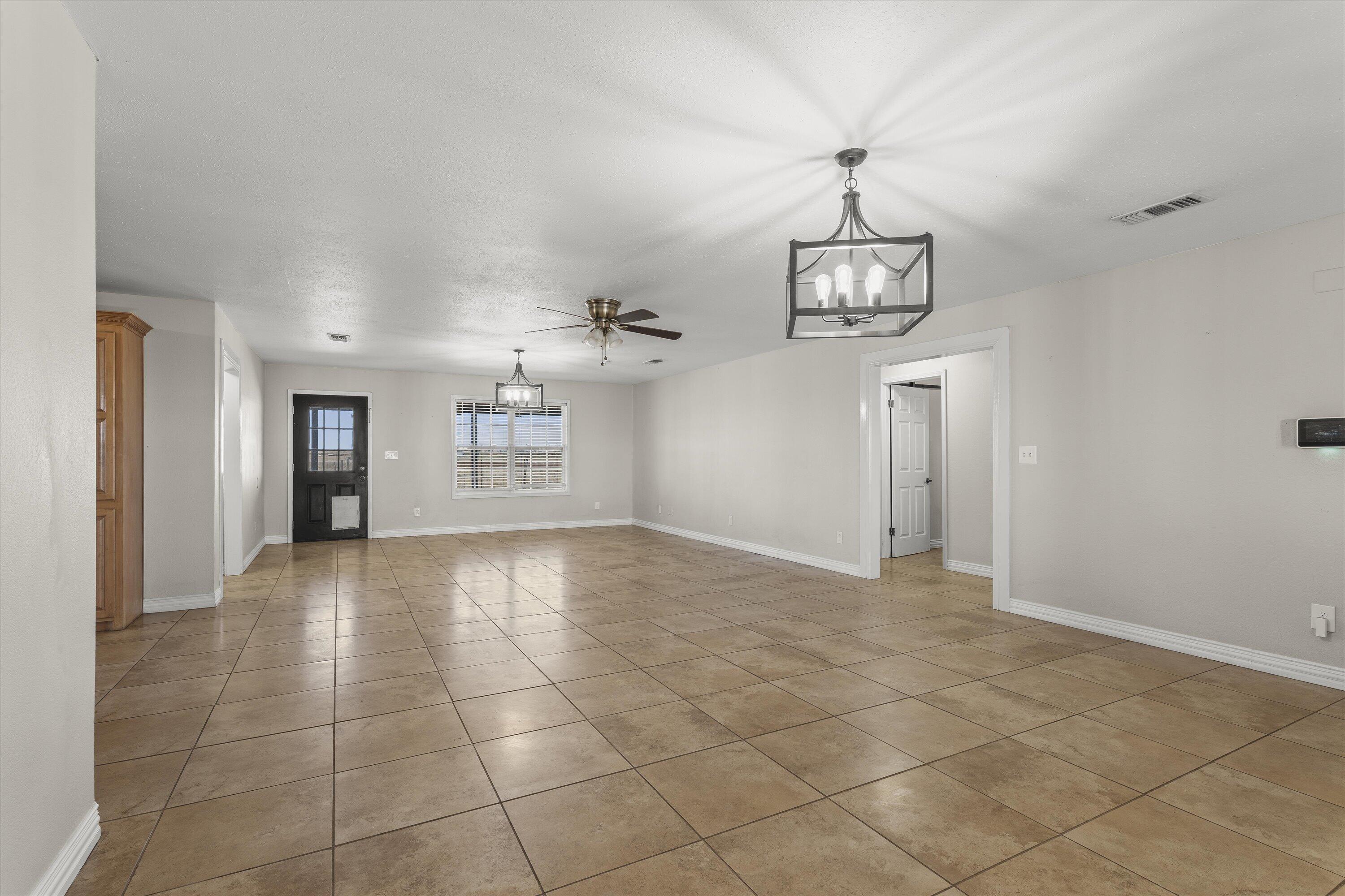 3131 North Alamo Road Levelland, TX 79336 - Photo 4 of 32 a view of an empty room and a window