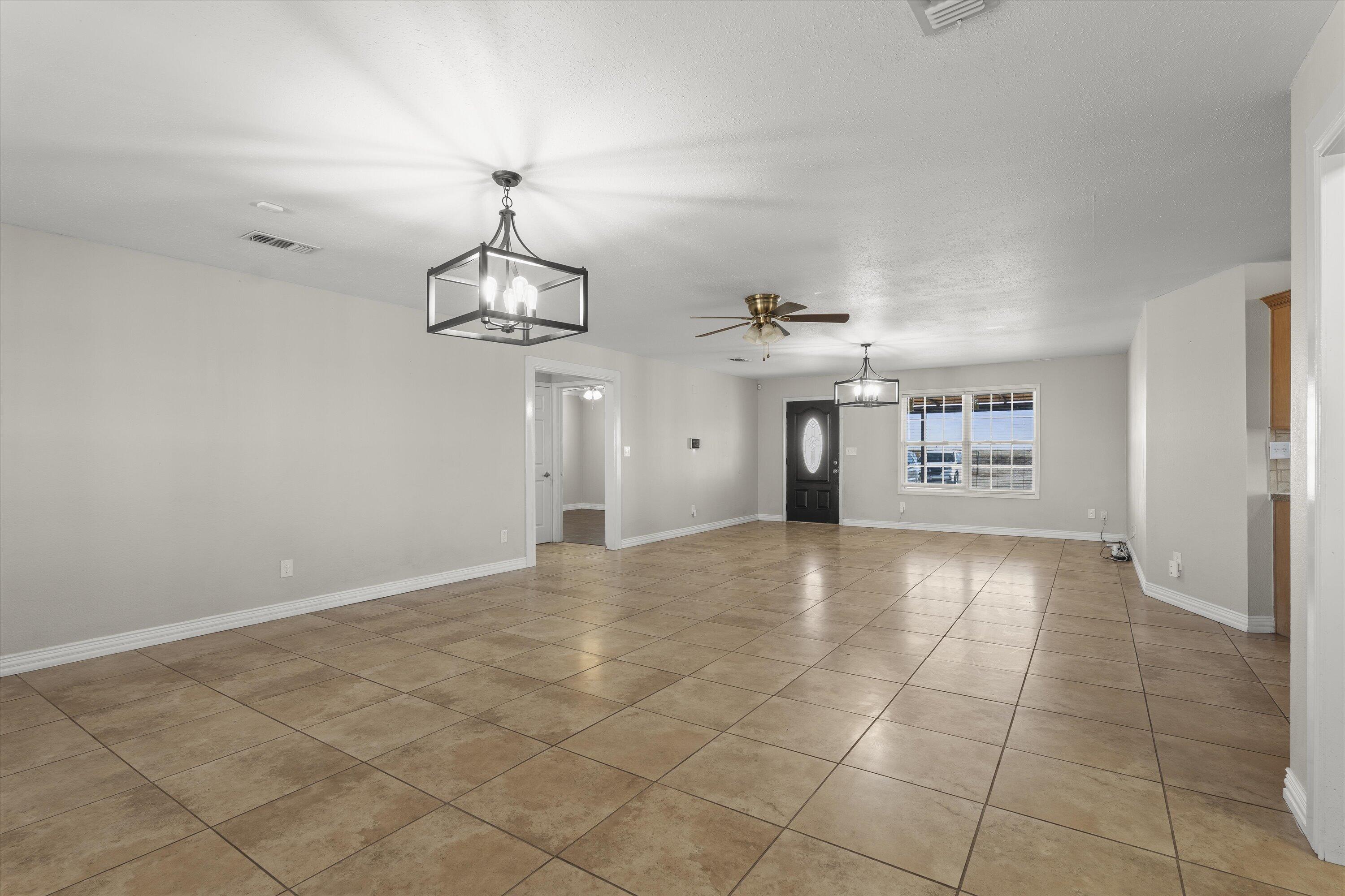 3131 North Alamo Road Levelland, TX 79336 - Photo 5 of 32 a view of a kitchen with a sink and a chandelier