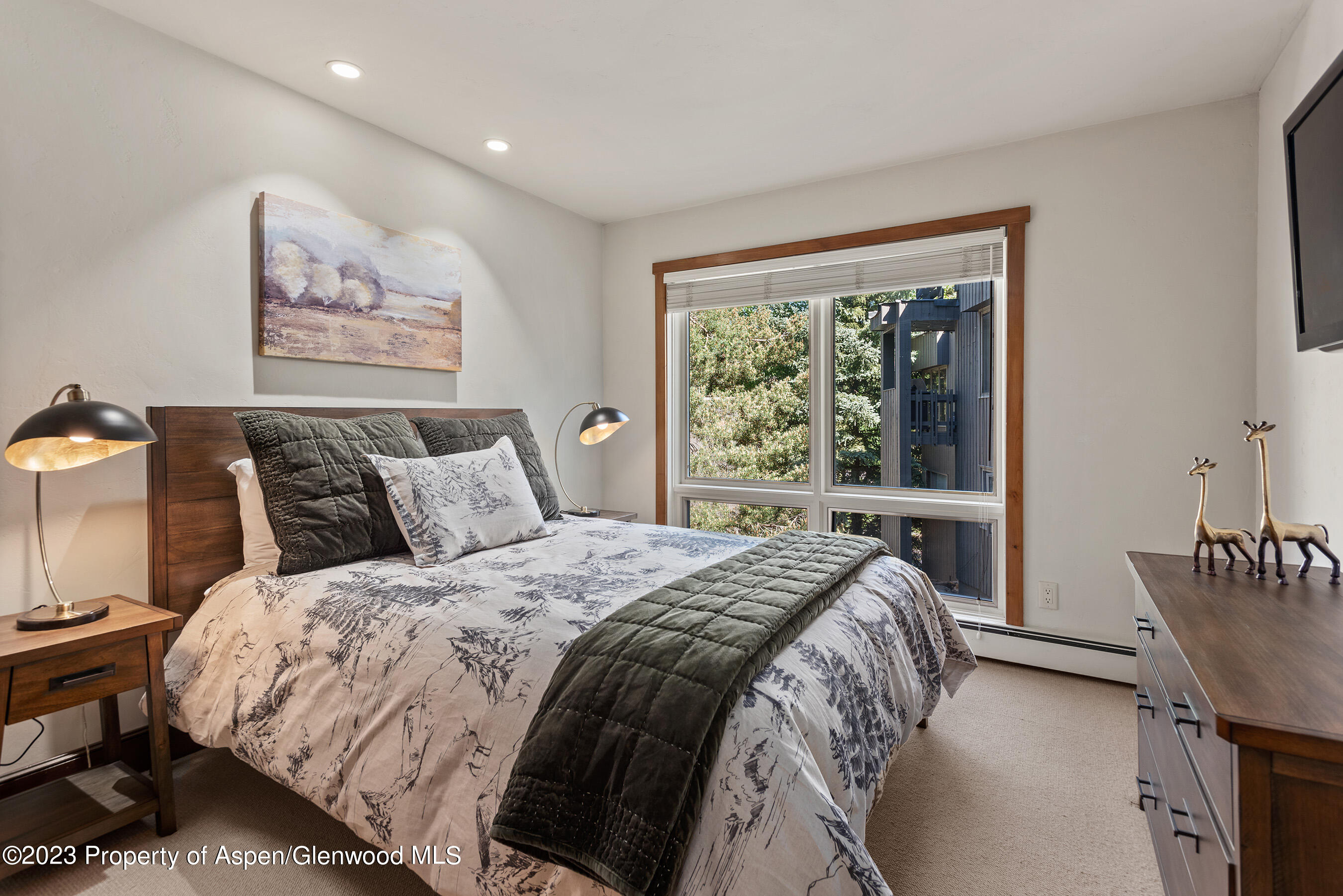 232 Meadow Ranch Road Snowmass Village, CO 81615 - Photo 13 of 18 a bed sitting in a bedroom next to a window