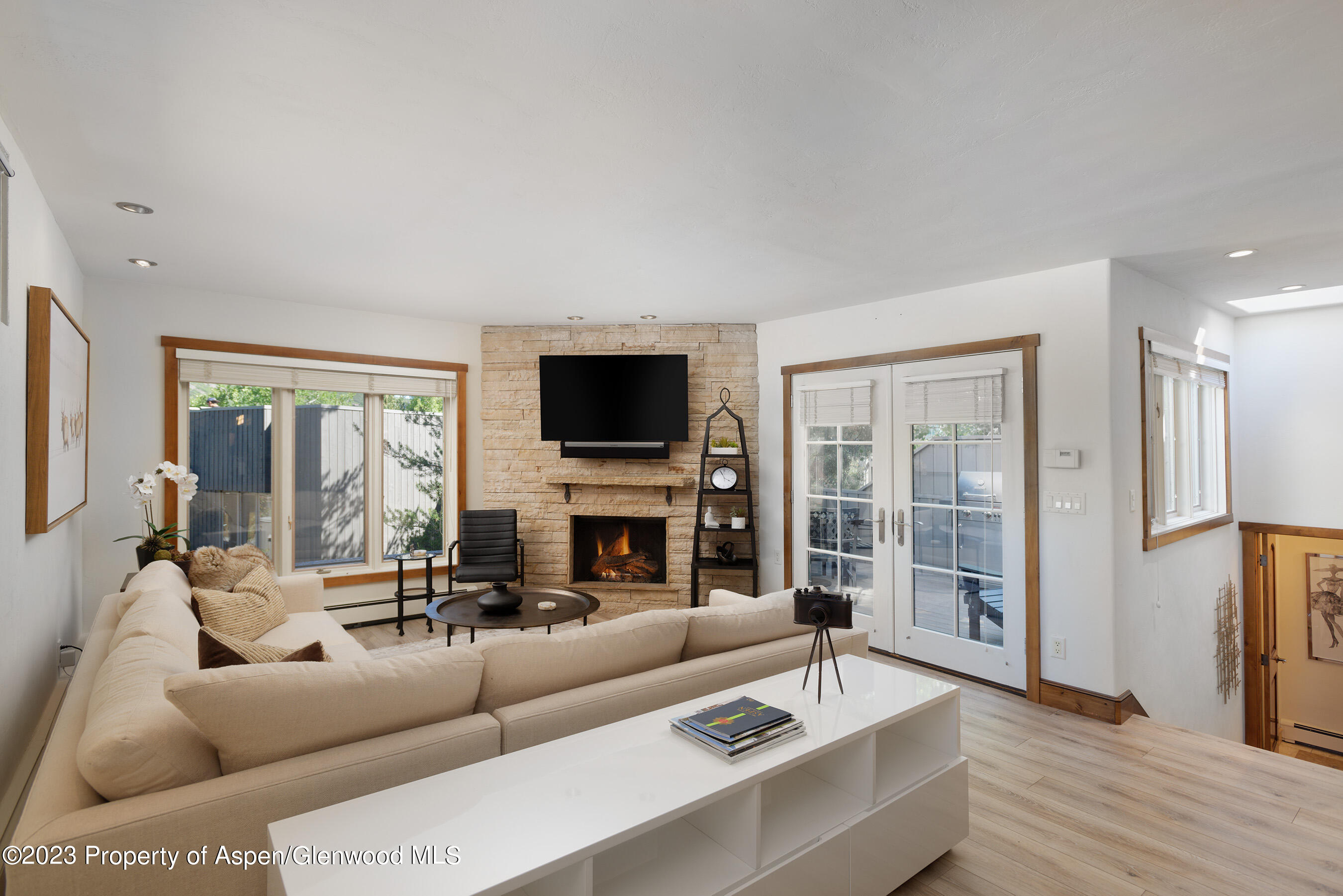 232 Meadow Ranch Road Snowmass Village, CO 81615 - Photo 3 of 18 a living room with furniture and a flat screen tv with wooden floor