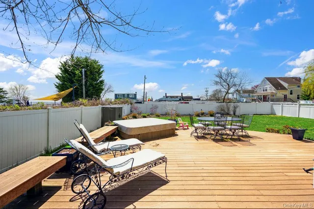 a view of a terrace with furniture and a garden