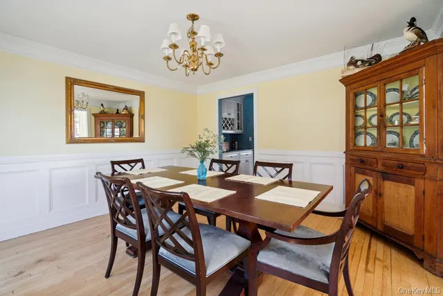 a view of a dining room with furniture and chandelier