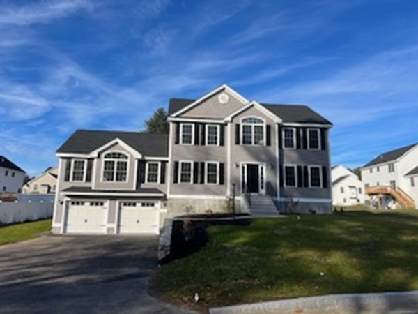 60 Hayfield Road Dracut, MA 01826 - Photo 1 of 1 a front view of a house with a garden and trees