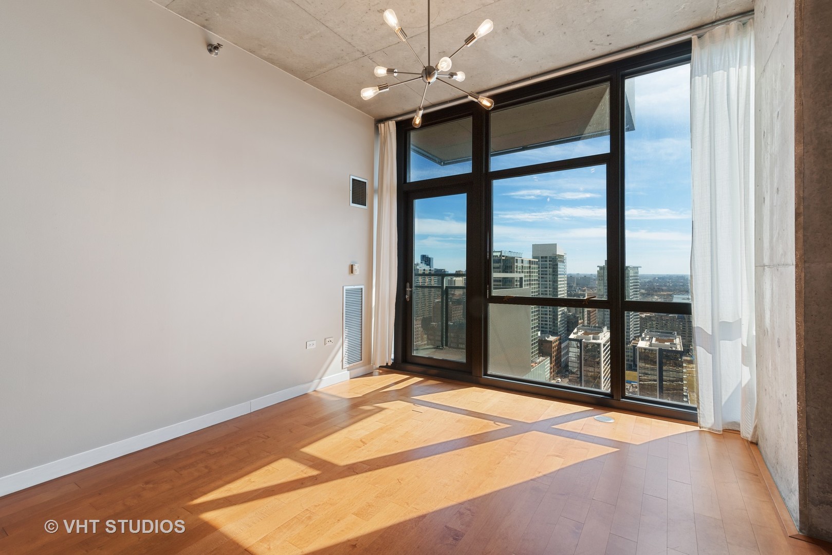 235 West Van Buren Street, Unit 2905 Chicago, IL 60607 - Photo 2 of 18 a bedroom with a large bed and a large window