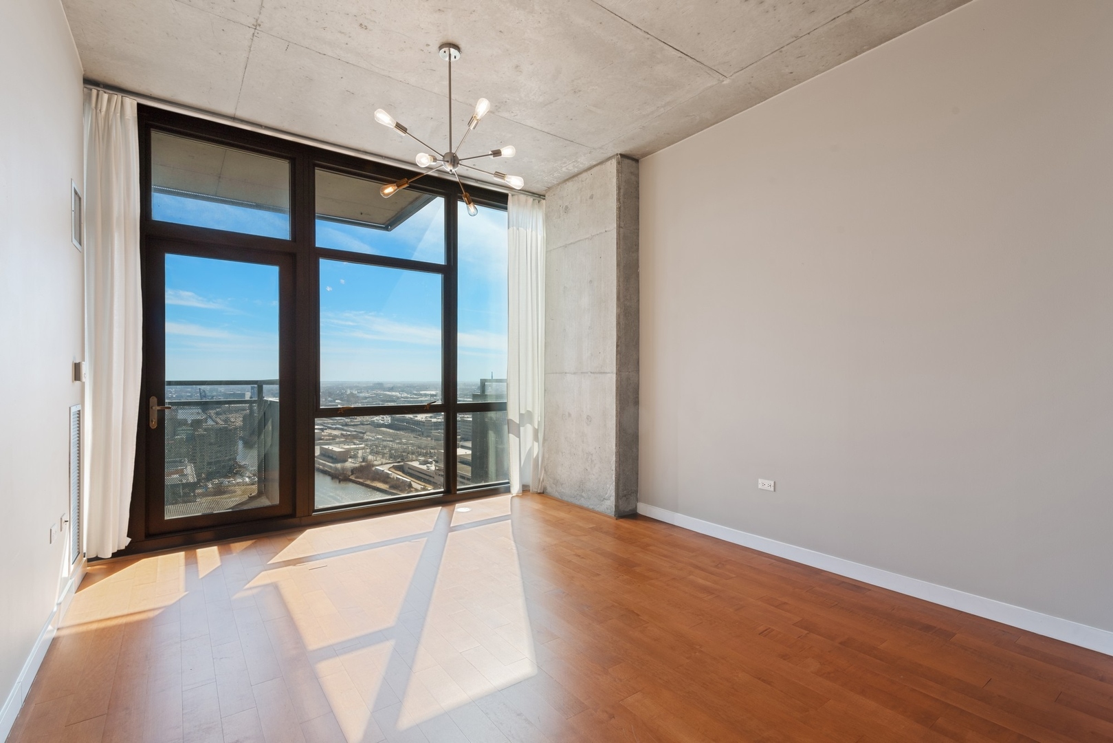 235 West Van Buren Street, Unit 2905 Chicago, IL 60607 - Photo 3 of 18 a view of an empty room with a window