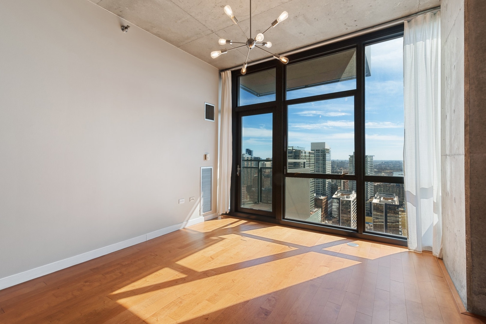 235 West Van Buren Street, Unit 2905 Chicago, IL 60607 - Photo 4 of 18 a bedroom with a large bed and a large window