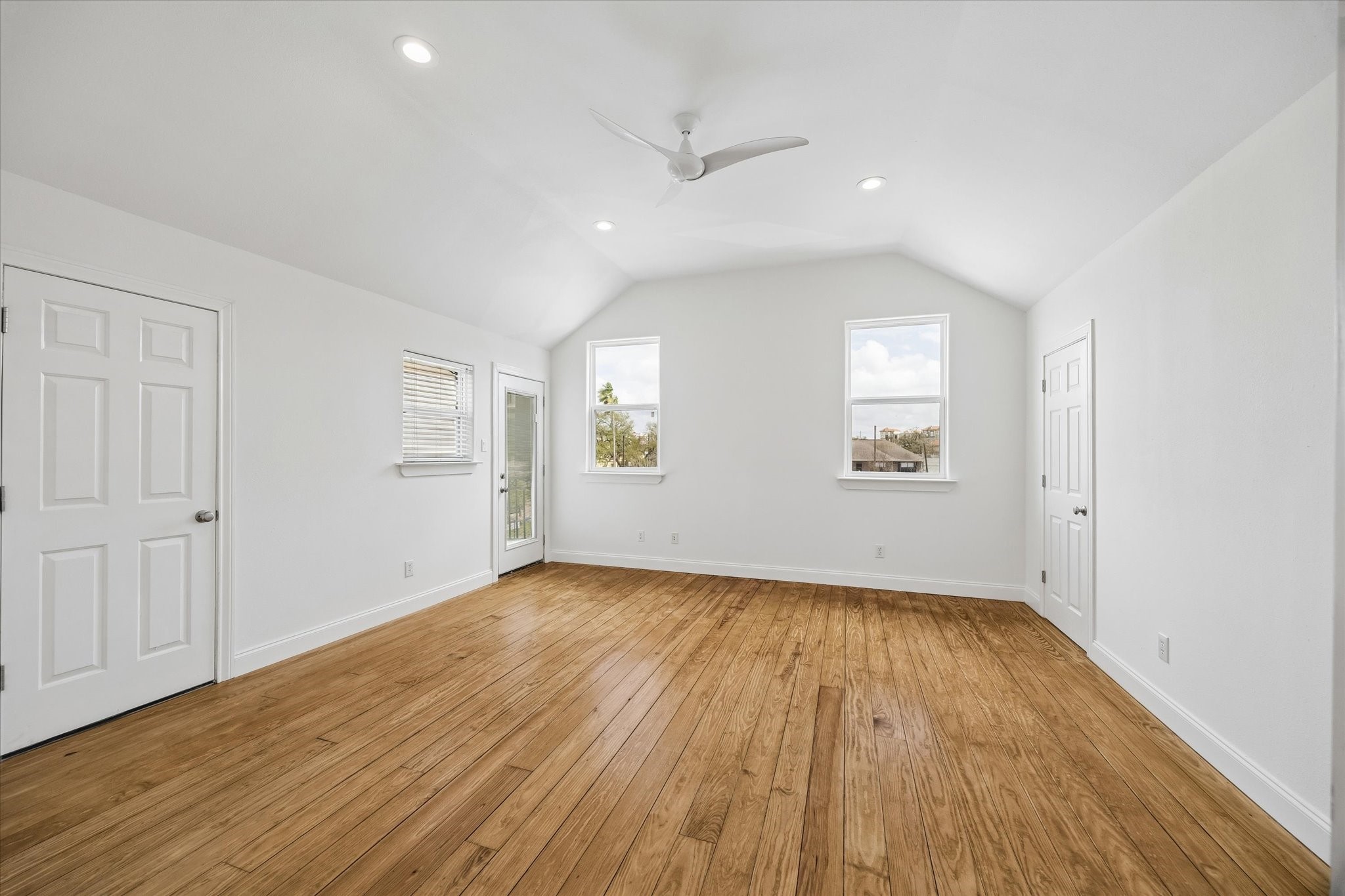 4011 Garrott Street Houston, TX 77006 - Photo 14 of 19 an empty room with wooden floor and windows
