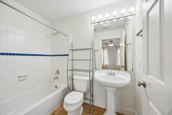 a bathroom with a sink toilet tub and shower