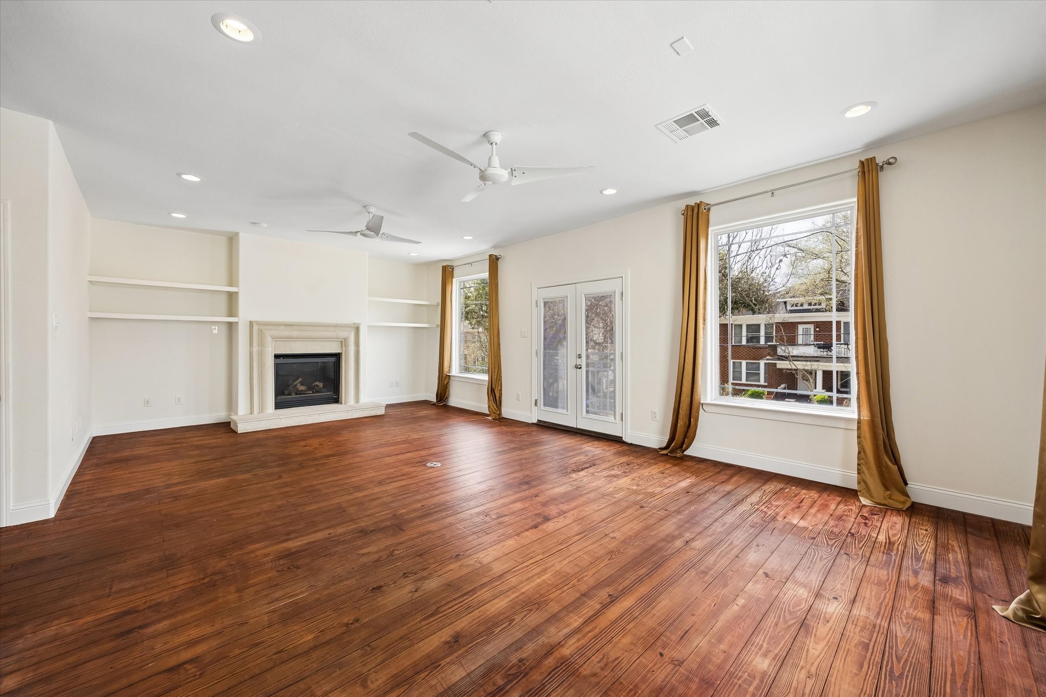 4011 Garrott Street Houston, TX 77006 - Photo 6 of 19 a view of livingroom with hardwood floor and a ceiling fan