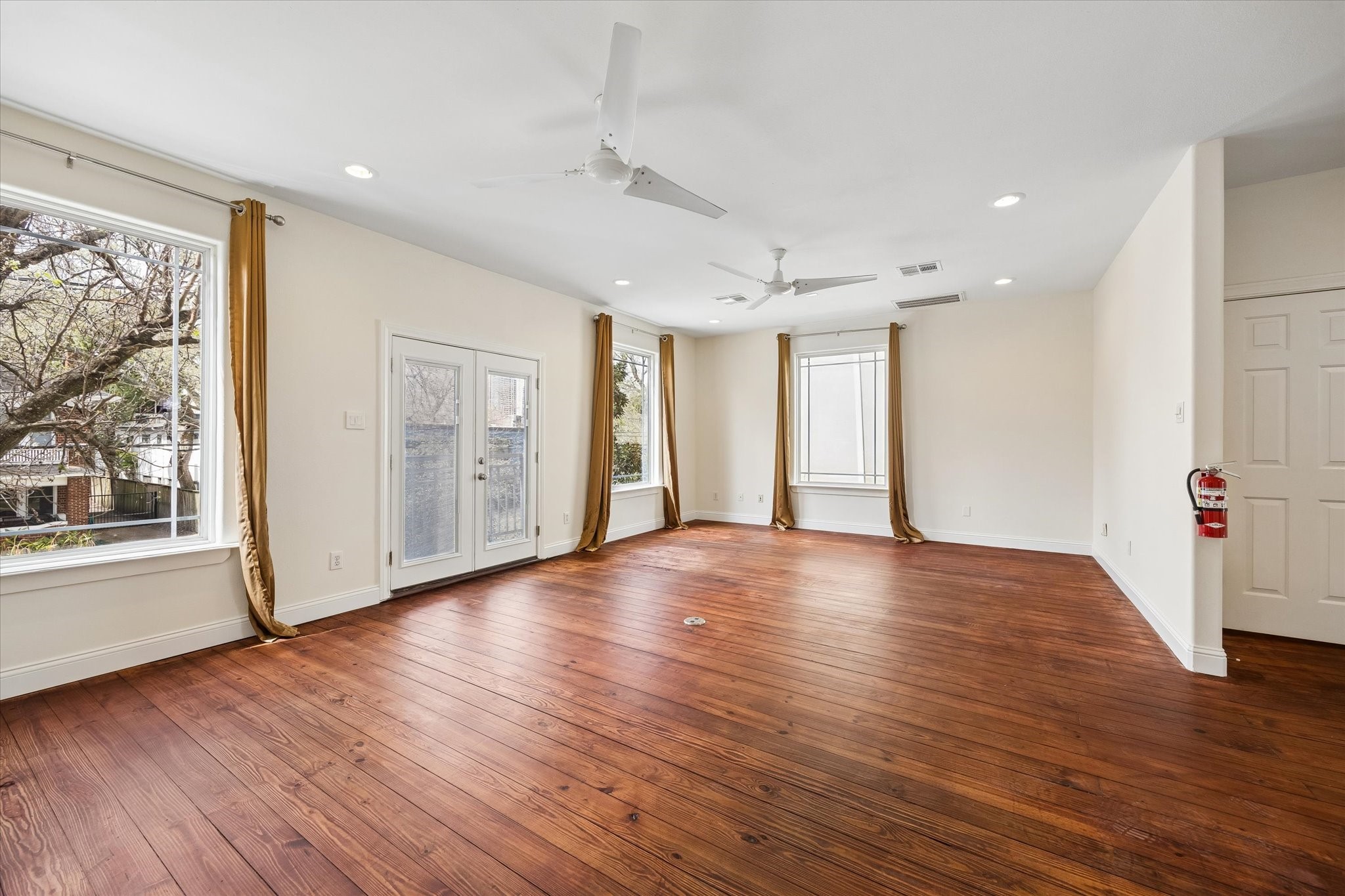 4011 Garrott Street Houston, TX 77006 - Photo 8 of 19 a view of an empty room with wooden floor and a window