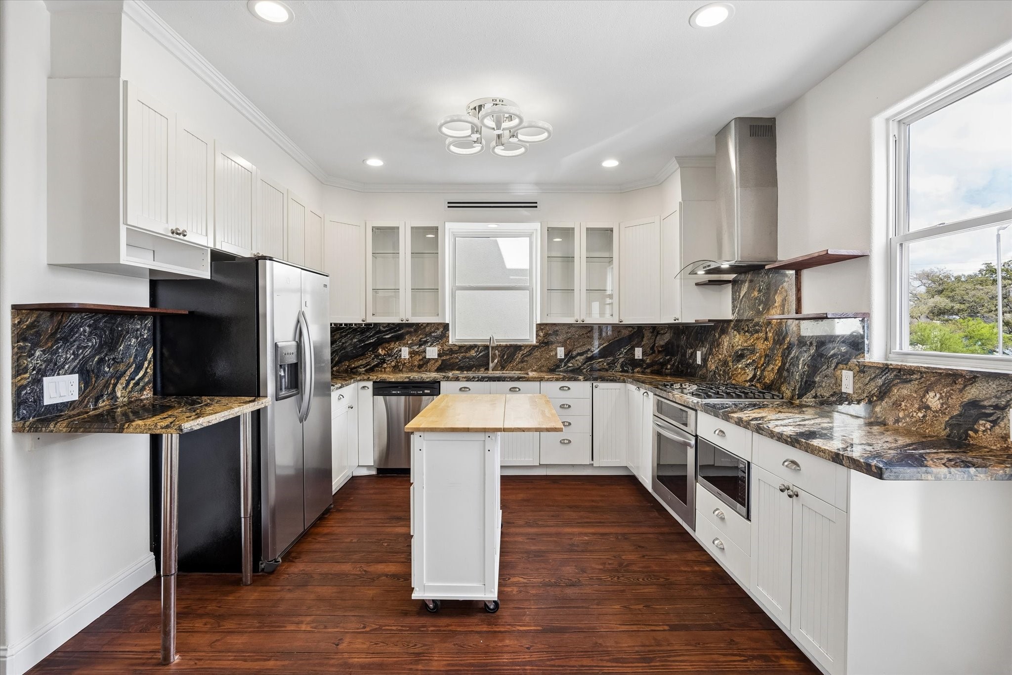 4011 Garrott Street Houston, TX 77006 - Photo 9 of 19 a kitchen with white cabinets and appliances