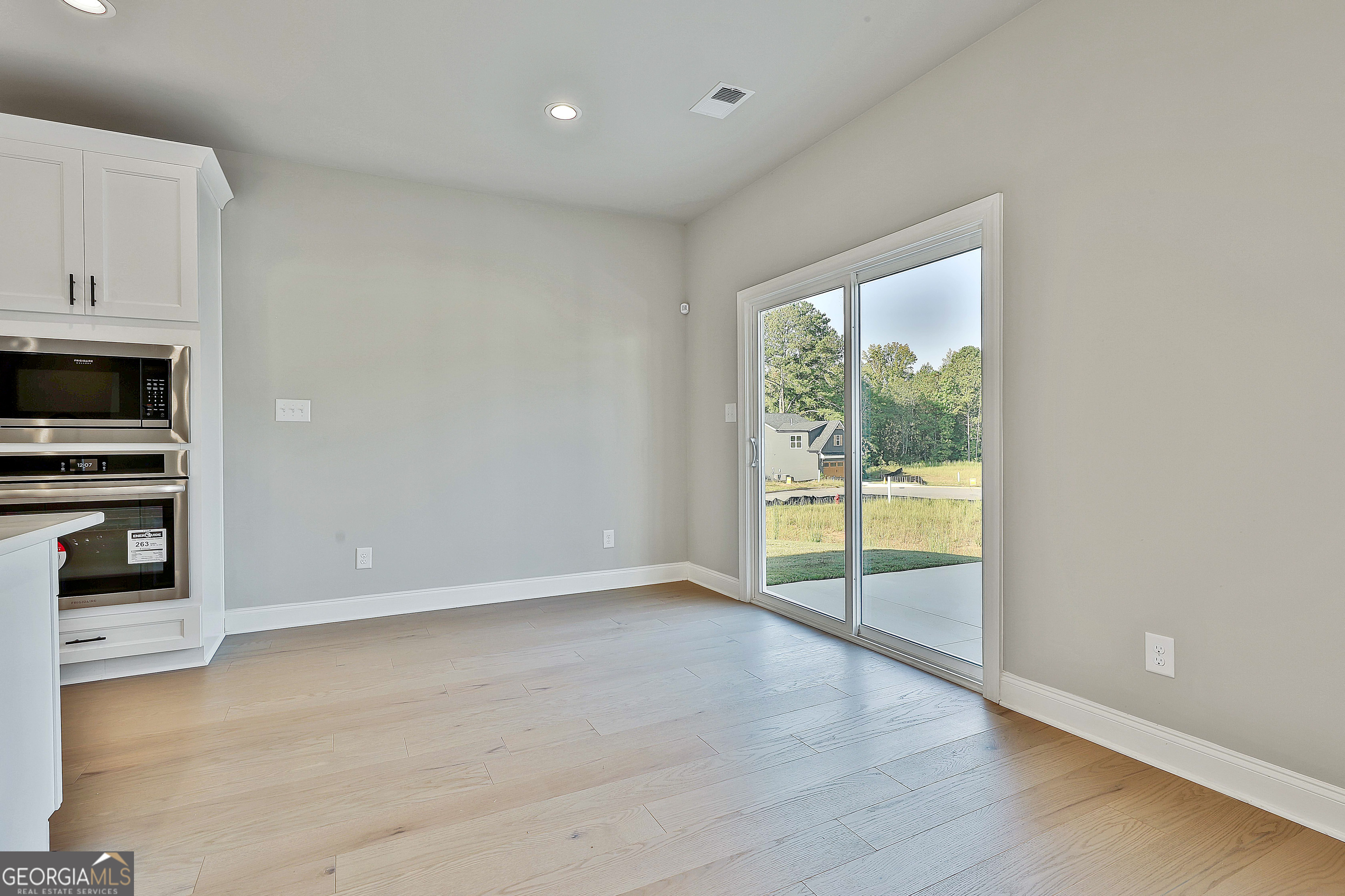 6 Leverett Drive, Unit 17 Newnan, GA 30265 - Photo 12 of 35 a view of an empty room with a window and wooden floor