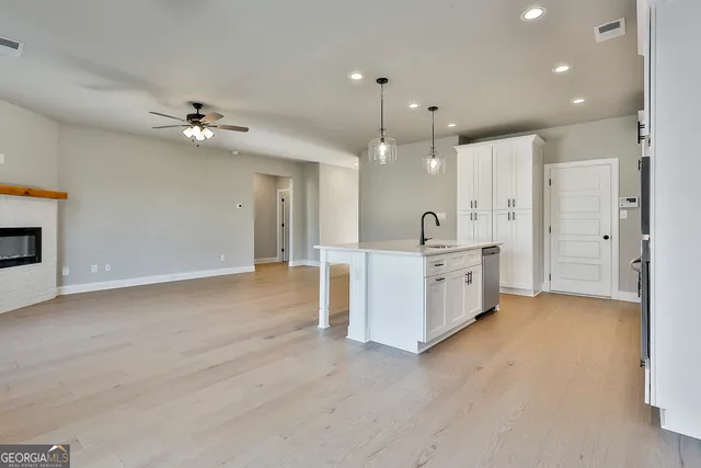 a view of a kitchen with a sink and refrigerator
