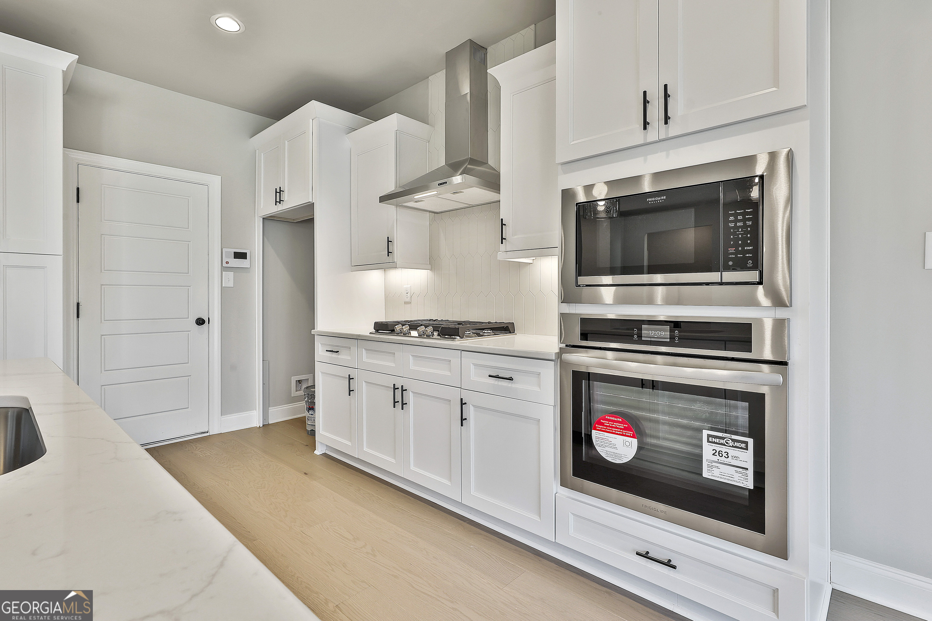 6 Leverett Drive, Unit 17 Newnan, GA 30265 - Photo 16 of 35 a kitchen with stainless steel appliances a stove a microwave and cabinets