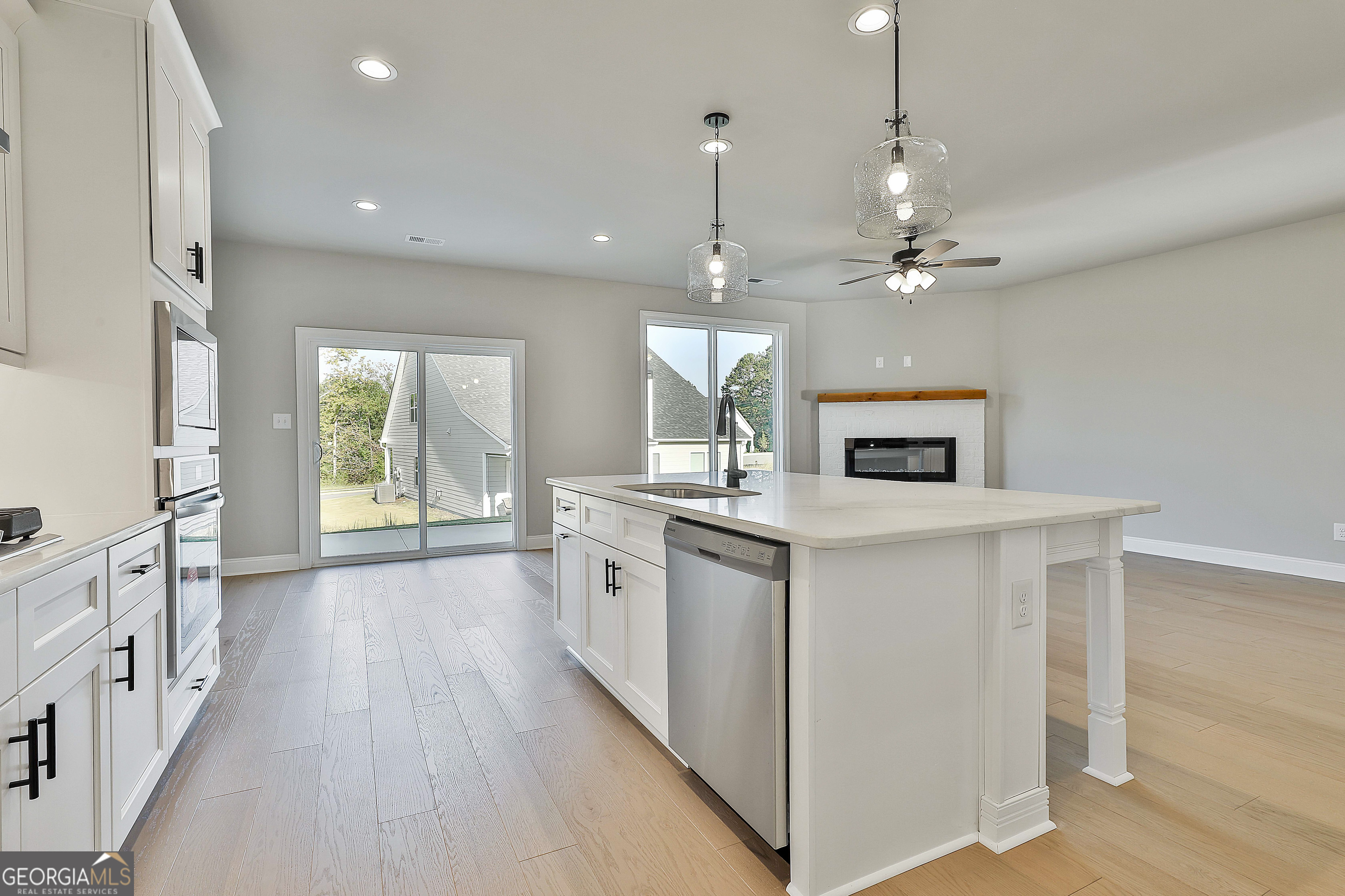 6 Leverett Drive, Unit 17 Newnan, GA 30265 - Photo 17 of 35 a kitchen with stainless steel appliances granite countertop a sink a stove a refrigerator and a window
