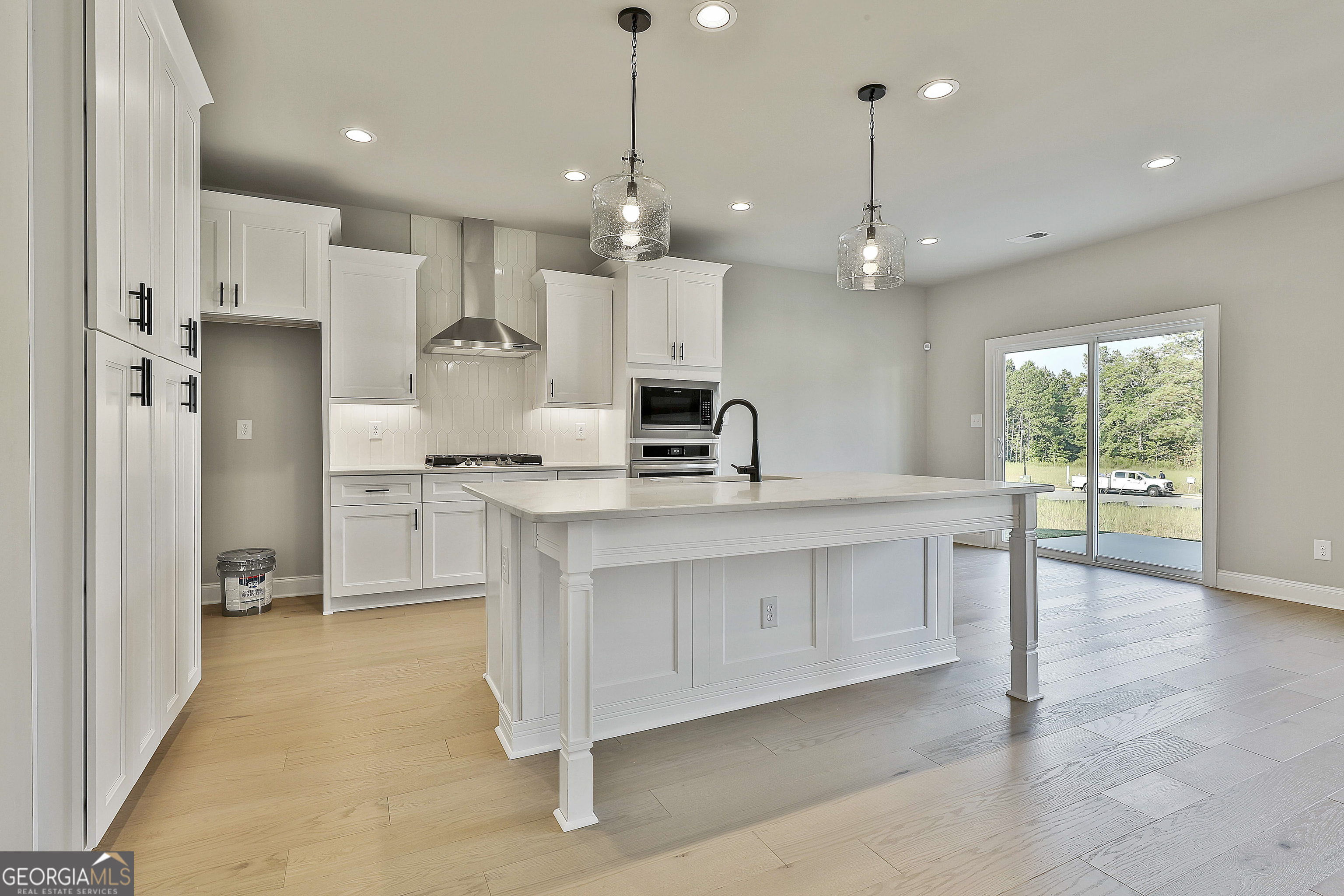 6 Leverett Drive, Unit 17 Newnan, GA 30265 - Photo 18 of 35 a large kitchen with white cabinets stainless steel appliances a sink and a large window