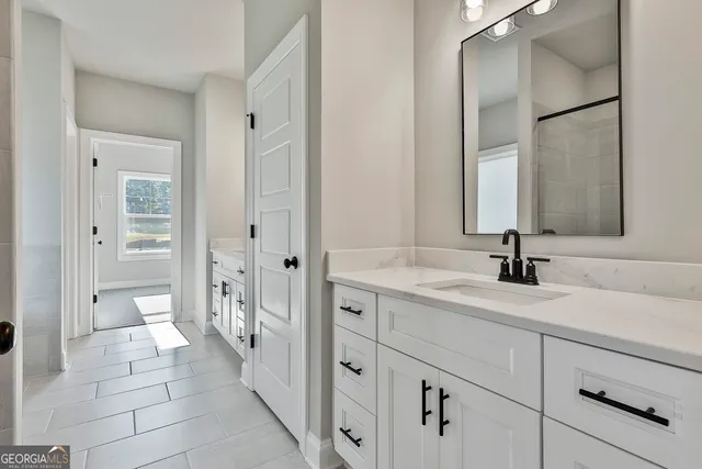 a spacious bathroom with a double vanity sink mirror and double
