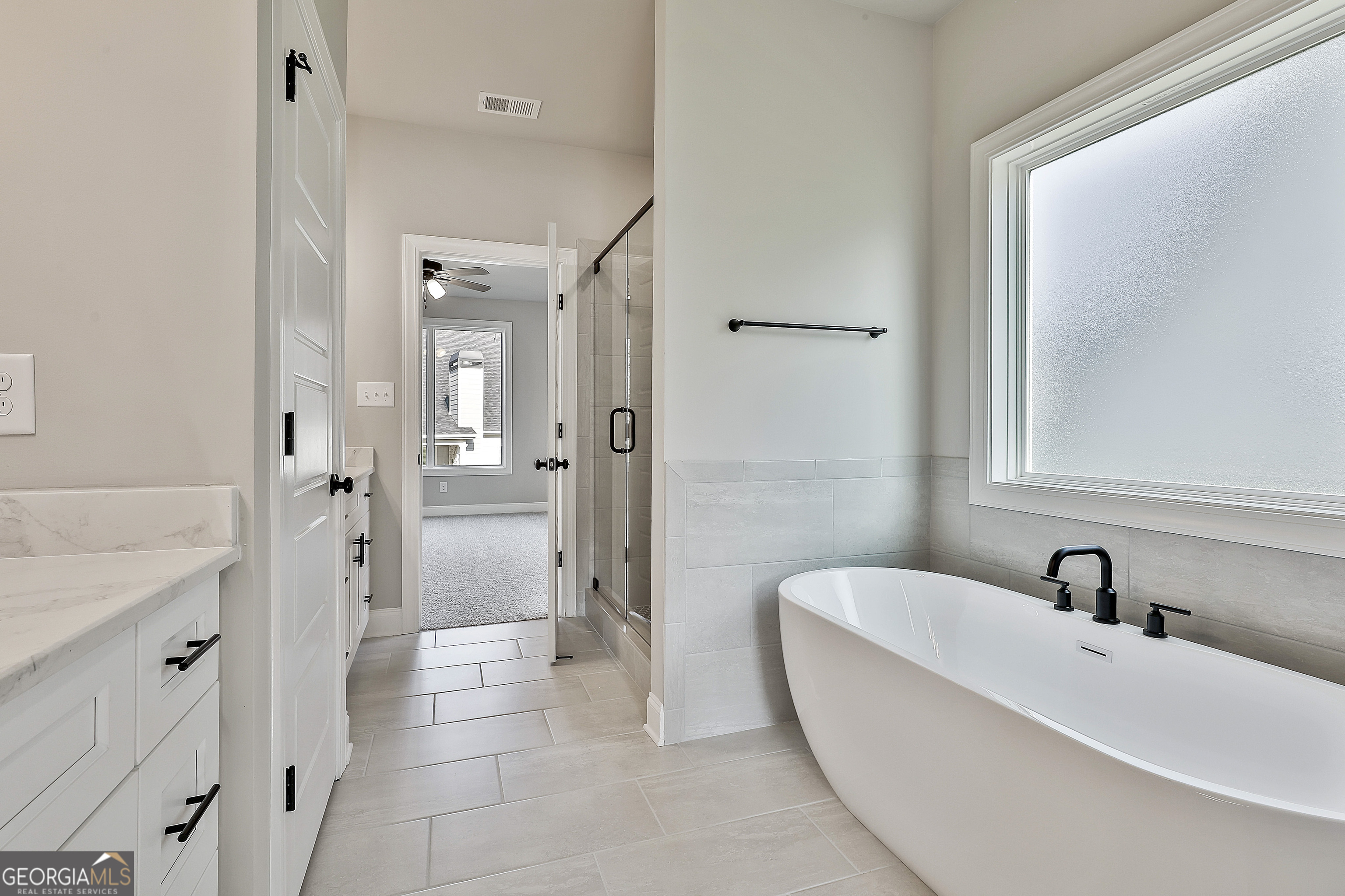 6 Leverett Drive, Unit 17 Newnan, GA 30265 - Photo 23 of 35 a bathroom with a tub sink shower and mirror
