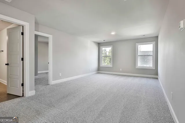 an empty room with windows and closet