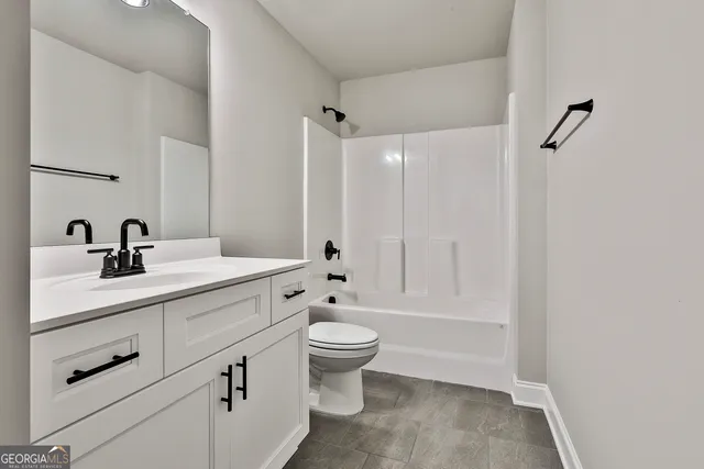 a bathroom with a double vanity sink toilet and shower