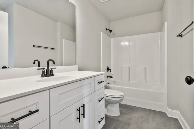 a bathroom with a double vanity sink toilet and shower