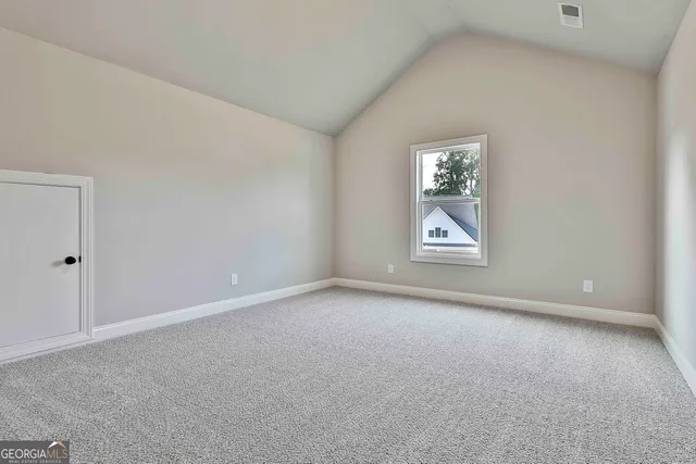 an empty room with windows and closet
