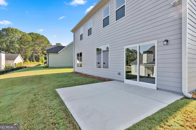 front view of a house with a yard and potted plants