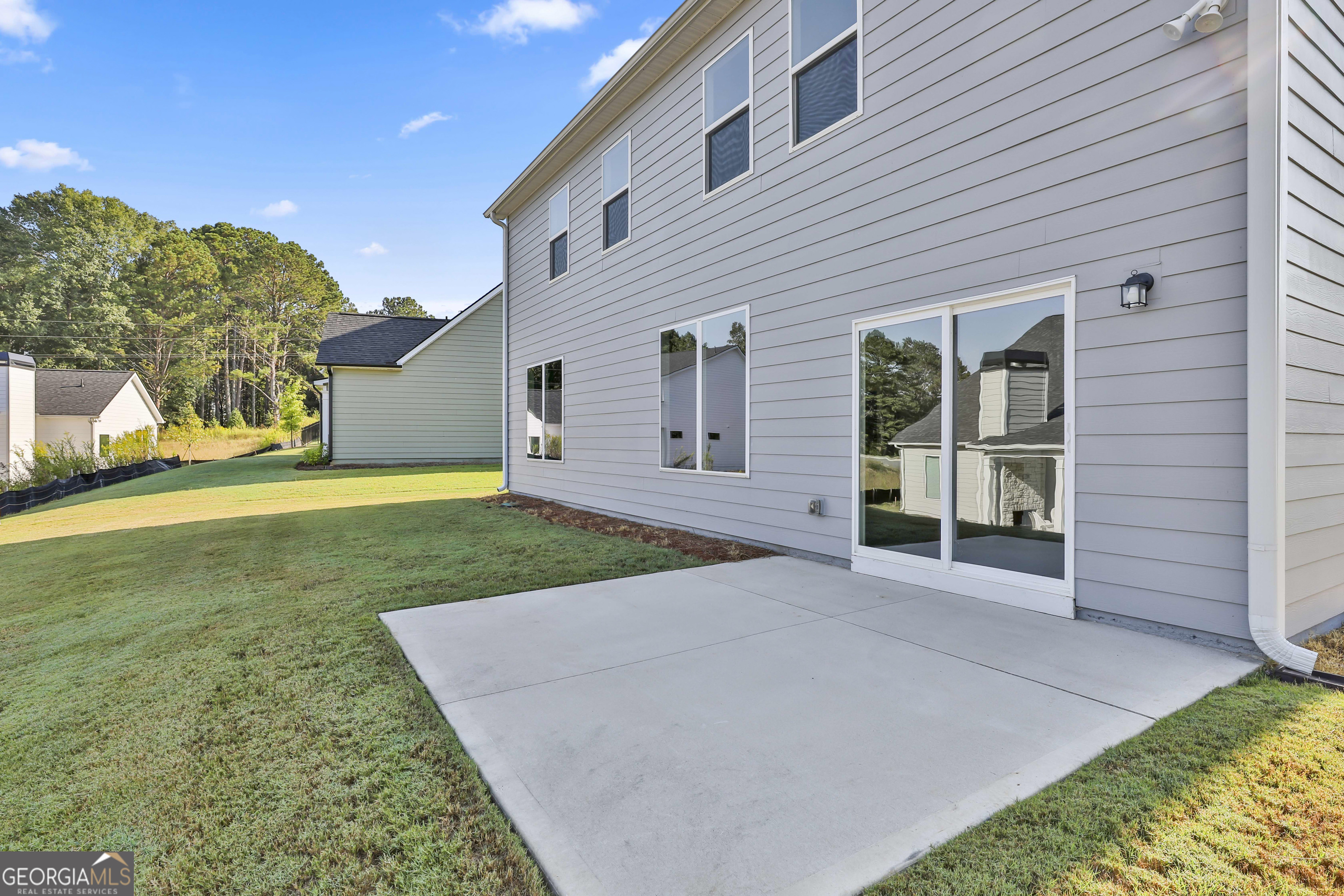 6 Leverett Drive, Unit 17 Newnan, GA 30265 - Photo 34 of 35 front view of a house with a yard and potted plants